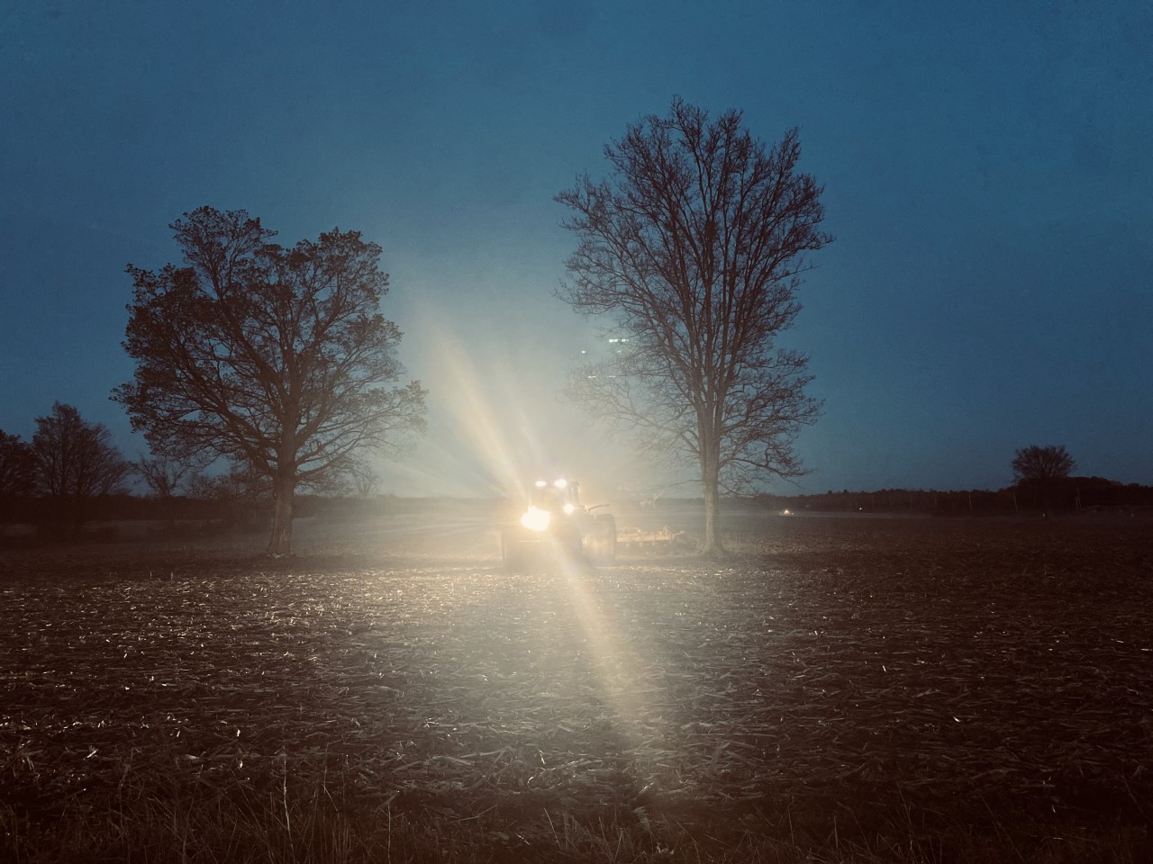Tractor at night in a field