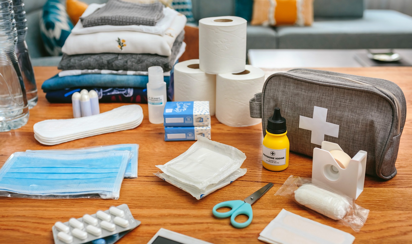 Emergency backpack equipment with first aid kit organized on the table in the living room